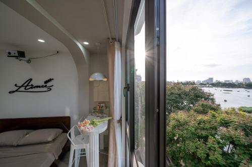 a room with a window with a view of the water at Aimee House Homestay Trấn Vũ in Hanoi