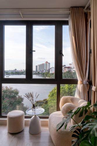 a living room with a large window with a view at Aimee House Homestay Trấn Vũ in Hanoi