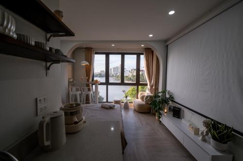 a living room with a large window and a couch at Aimee House Homestay Trấn Vũ in Hanoi