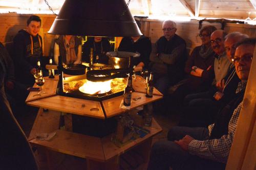 a group of people sitting around a table with a lamp at Hotel Haus Rameil in Lennestadt
