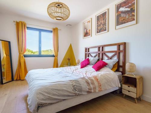 a bedroom with a bed with pink pillows and a window at Cambo-les-Bains : Maison 3 Pièces, Piscine Privée, Internet, Parking - FR-1-495-148 in Cambo-les-Bains