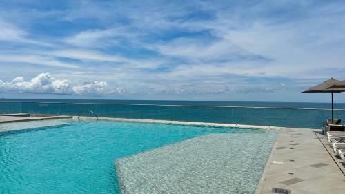 a swimming pool with a view of the ocean at Namaste Alojamientos Luxury Cartagena in Cartagena de Indias