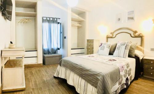 a bedroom with a bed with a dresser and a mirror at Apartment Alegria in the stunning Village of Mozaga, Lanzarote in Mozaga