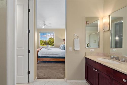 a bathroom with a sink and a bedroom with a bed at F22 Waikoloa Fairway Villas in Waikoloa