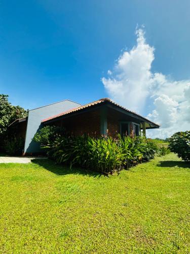 a small house with a grassy yard in front of it at Foresta Resort Sigiriya in Sigiriya