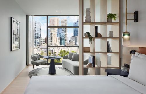 a hotel room with a bed and a living room at Lanson Place Parliament Gardens in Melbourne