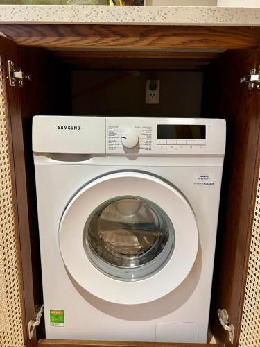 a washer and dryer in a cabinet at Aqua Blue Ocean View Condo - Free Swimming Pool in Hà My Tây (2)