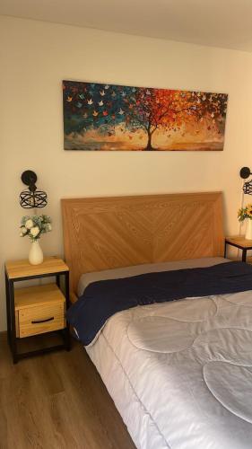 a bedroom with a bed and a painting on the wall at Mambo House 702 in Bogotá