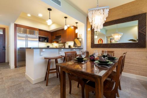 a kitchen and dining room with a wooden table and chairs at 14B Halii Kai in Waikoloa