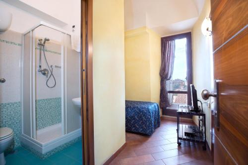 a bathroom with a shower and a toilet and a sink at Albergo Dei Leoni in Monterotondo