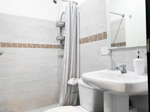 a bathroom with a sink and a toilet and a shower at 3 dormitorios piscina privada BBQ parking free in SamborondÃ³n