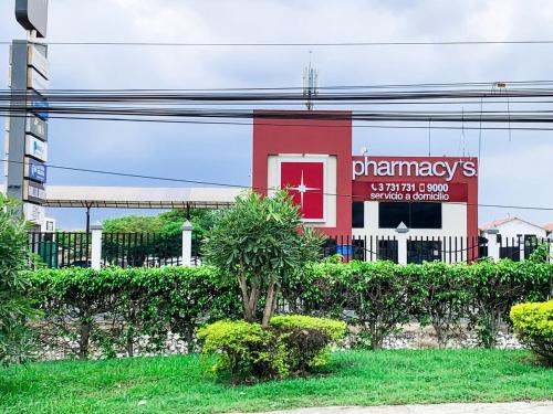 a building with a pharmacy sign in front of it at 3 dormitorios piscina privada BBQ parking free in SamborondÃ³n