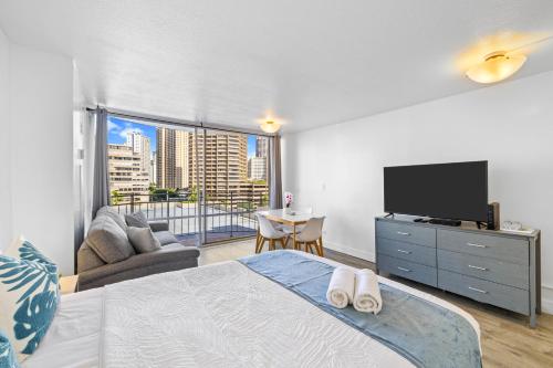 a bedroom with a bed and a flat screen tv at Waikiki Ilikai Marina in Honolulu