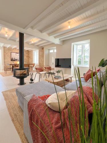 a living room with a bed and a fireplace at Siavo Junto a la Ría in Outes