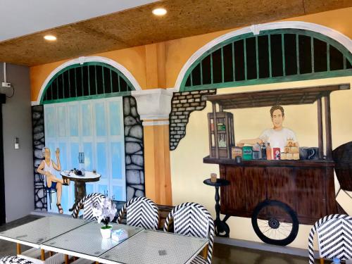a room with a painting of a man in a kitchen at Chomview Lanta Water Park Resort in Ko Lanta