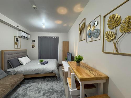 a bedroom with a bed and a desk in it at The Aquascape in Lapu Lapu City