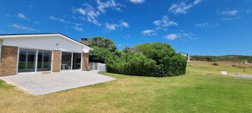 a house with a large yard with green grass at Pearly Bay in Pearly Beach
