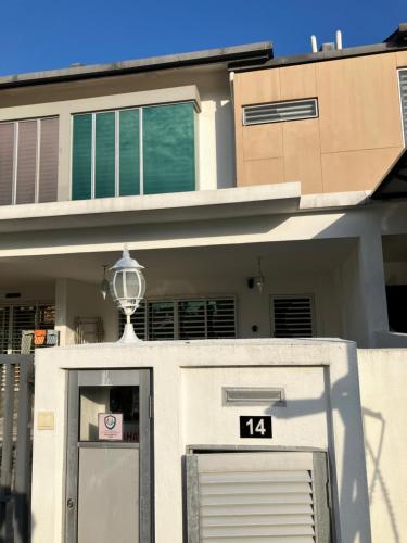 a white house with a door and a sign on it at D'Sally Homestay KLIA Sepang in Sepang