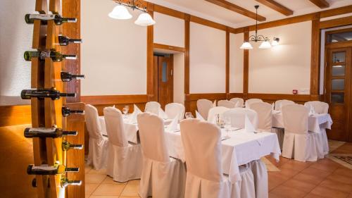 a room with white tables and chairs in it at Hotel Knez in Kupres