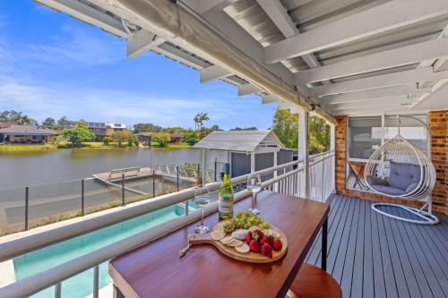 a table on a balcony with a view of the water at Waterfront Paradise in Tweed Heads