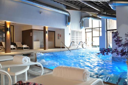 a large swimming pool in a hotel room at Puebloastur Eco Resort Hotel & Spa in Cofiño