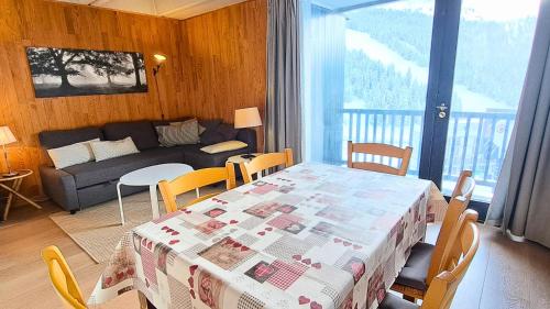 un salon avec une table et un canapé dans l'établissement Résidence Aldébaran - maeva Home - Appartement 2 Pièces 6 Personnes - Confort MAE-3806, à Arâches-la-Frasse