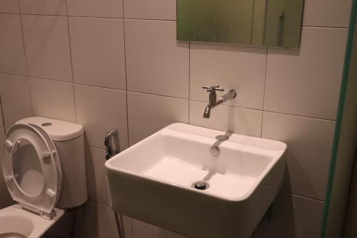 a bathroom with a sink and a toilet at Oscar Inn in Petaling Jaya