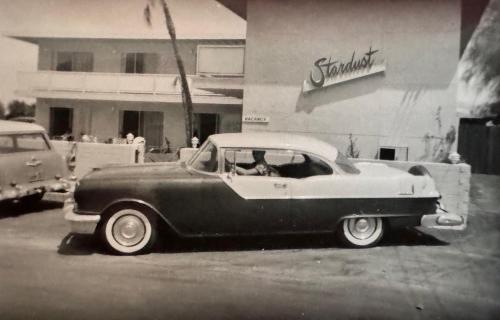 an old car parked in front of a building at The Stardust Hotel - Adults Only in Palm Springs