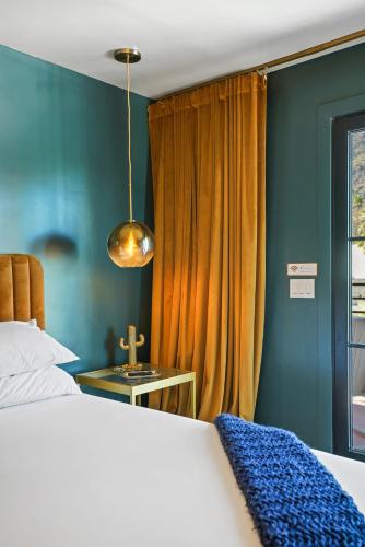 a bedroom with a bed and a window at The Stardust Hotel - Adults Only in Palm Springs
