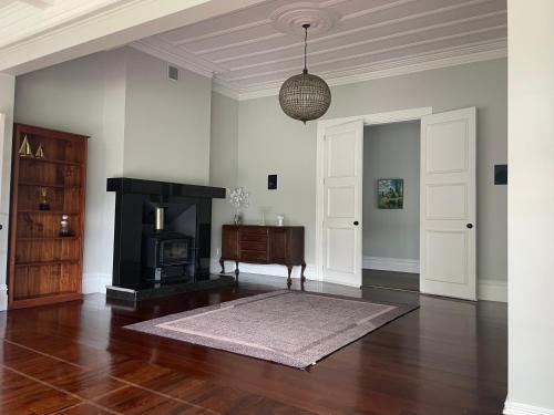 a living room with a fireplace and a table at Winter Fun - Spa, Pinball, Billiard and more in Kumeu