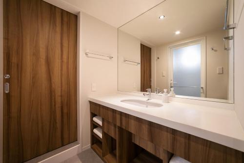 a bathroom with a sink and a mirror at Oriental Hotel Tokyo Bay in Urayasu