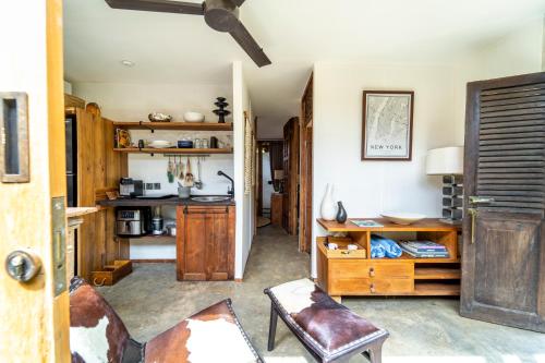 a room with a kitchen with a table and chairs at Salty Siesta Stays in Selong Belanak