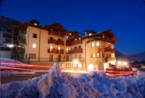 a pile of snow in front of a building at Gaia Residence Hotel in Mezzana