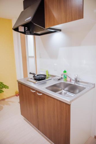 a kitchen with a sink and a stove at valuehjq VALUE NAMBA SOUTH III in Osaka