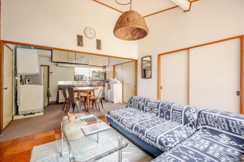 a living room with a couch and a table at KIKA STAY - 10sec Yumigahama Beach 3bed rooms 弓ヶ浜ビーチの目の前 BBQ可能 in Minamiizu