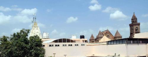 a large white building with turrets and a tower at City Guest House in Bhuj