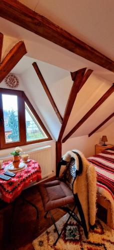a bedroom with a bed and a table and a chair at Vlad De Săliște in Săliştea de Sus