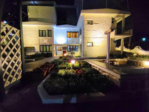 a house with a garden in front of it at night at 7 ROADS RESORT 50mts to lake in Kodaikānāl