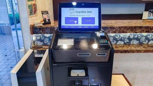 an atm machine with a laptop on top of it at Toyoko Inn Tokyo Shinagawa Hatanodai eki Minami guchi in Tokyo