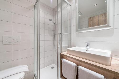 a bathroom with a sink and a toilet and a shower at A Casa Saphir Appartement-Hotel in Sölden