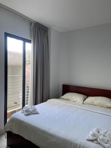 Ένα ή περισσότερα κρεβάτια σε δωμάτιο στο Residence 110 (Hotel and Apartments)