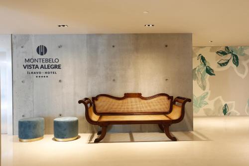 a bench in a room with two blue stools at Montebelo Vista Alegre Ílhavo Hotel in Ílhavo