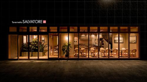 a store front of a building with tables and chairs at Daiwa Roynet Hotel Akita Ekimae in Akita