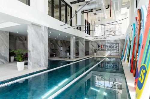 a swimming pool in a building with skis on the wall at Sea Breeze Resort, Beachfront apartment with a balcony and sea view in Nardaran