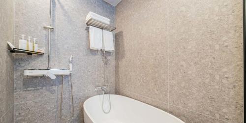 a bathroom with a shower and a toilet and a sink at The hound hotel bandalseom2 in Ansan