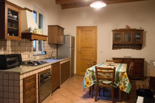 a kitchen with a table and a stove top oven at Mari Terra e Focu in Acireale