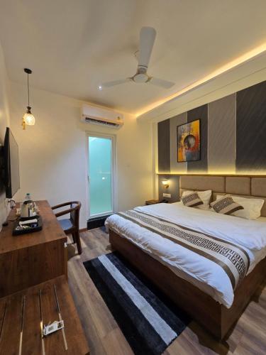 a bedroom with a large bed and a television at Hotel Fortune in Ayodhya