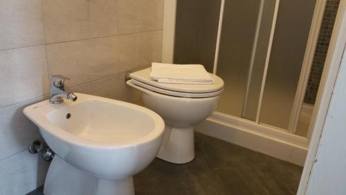 a bathroom with a toilet and a sink at Albergo Sonia in Florence