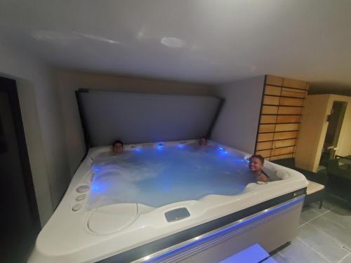 2 personnes dans un bain à remous dans une chambre dans l'établissement Perce neige, à Morillon