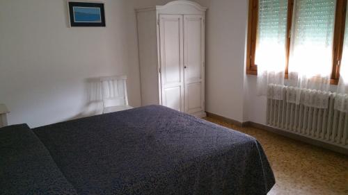 a bedroom with a blue bed and a window at Albergo Sonia in Florence